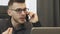 Angry businessman talking on phone, close up. Portrait of upset man talks on smartphone with employee in office. Annoyed male dire