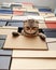 Angry cat Scottish Fold climbed into a pile of folded shoe boxes and stares down sternly