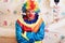 Angry clown with rainbow colored hairstyle.