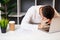 Angry company employee sits at a white table