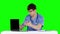 Angry doctor posing at table. Green screen