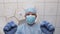 Angry doctor in rubber glove stands over patient in operating room