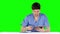 Angry doctor using a tablet and makes records. Green screen
