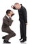 Angry employer shouting and pointing at a crouched employee