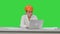 Angry female engineer in hardhat with documents in stress because of result on a Green Screen, Chroma Key.