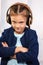 Angry funny serious kid girl in blue jacket listening the music