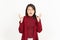 Angry Gesture Of Beautiful Asian Woman Wearing Red Shirt Isolated On White