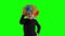 Angry girl with colorful clown wig looking at camera. Child negative emotion