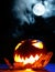 Angry halloween pumpkin and full moon