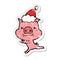 angry hand drawn distressed sticker cartoon of a pig wearing santa hat