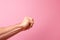 angry hand gesture on Pink background