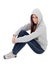 Angry hooded girl with grey sweatshirt sitting on the floor