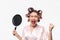 Angry housewife with curlers in hair standing