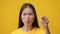 Angry Korean Female Talking Pointing Finger Blaming Someone, Yellow Background
