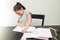 Angry little girl breaking the notebook on the black table. Concept of frustrated schoolgirl doing homework at home