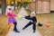 Angry mad children fighting for basket. Funny trick or treat on Halloween holiday. Kids boy and girl friends in party costumes can