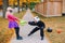 Angry mad children fighting for basket. Funny trick or treat on Halloween holiday. Kids boy and girl friends in party costumes can