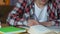 Angry male student throwing notebooks from table, examination stress, impatience