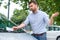 Angry man looking on parking ticket placed under windshield wiper