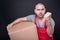 Angry mover man holding box showing fist