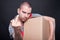 Angry mover man holding box showing obscene gesture