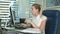 Angry office worker sitting at desk in office