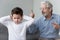 Angry old grandpa shouting at grandson close ears ignore grandfather