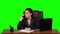 Angry phone conversation between the girl and her subordinate, she holds documents in her hands. Green screen. Slow