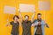 Angry protesting young people hold protest signs broadsheet blank placard on stick showing thumb down clenching fist