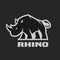 Angry rhino. Monochrome logo on a dark background.