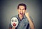 Angry screaming man holding clown mask expressing cheerfulness