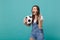 Angry screaming shocked young woman football fan support favorite team with soccer ball swearing looking aside isolated