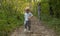 Angry small boy walking along the dirt road