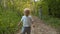 Angry small boy walking along the dirt road