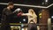 Angry sport woman training with coach at gym. Fit girl fighting on boxing ring