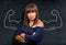 Angry and strong brunette woman at blackboard or chalkboard show