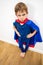 Angry superhero child being irritated by denigrating education, white background