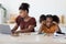 Angry teen girl sitting by working mom, kitchen interior