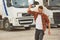 Angry, throwing the cap. Young truck driver in casual clothes