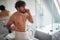 Angry topless man fighting while brushing teeth
