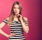 Angry unhappy suspicious thinking woman in striped dress looking