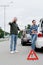 angry and upset drivers standing on road after