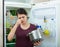 Angry and upset housewife looking into pot with foul meal