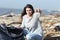 Angry volunteer cleaning a beach with thumbs down