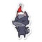 angry wolf sticker cartoon of a wearing santa hat