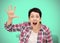 Angry woman isolated on neo mint background. Beautiful furious short haired brunette shouting and waving her palm hand