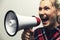 Angry woman with megaphone in hand