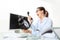 Angry woman at phone in office desk with clock, computer