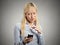 Angry young business woman pointing with finger at smartphone