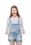 Angry young fashion girl in jeans overalls screaming isolated